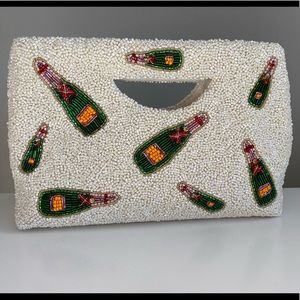 Beaded white clutch with champagne bottle design
